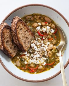 a white bowl filled with beans and bread