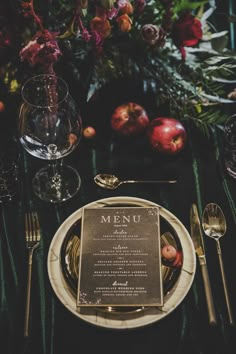 an elegant table setting with menu and silverware, apples and flowers in the background