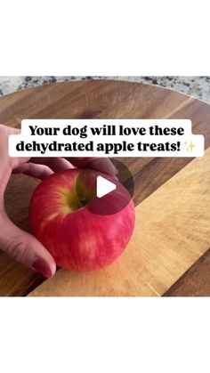 a person cutting an apple on top of a wooden board with the caption your dog will love these dehydrated apple treats