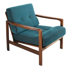 a teal chair with wooden frame and arms