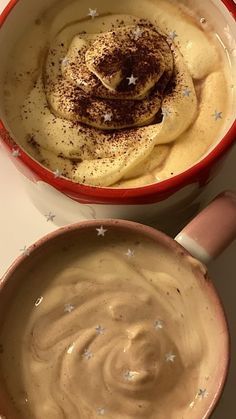 two bowls filled with food on top of a table