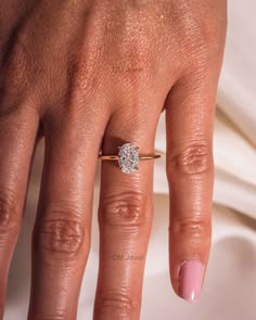 a woman's hand with a diamond ring on it