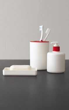 two toothbrushes and soap dispensers on a table