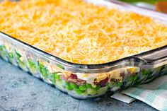 a casserole dish with green beans, cheese and other toppings in it