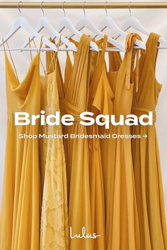 bridesmaid dresses hanging on a rack in front of a white background with the words bridal squad