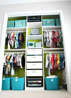 an organized closet with clothes, baskets and bins on the bottom shelf is shown