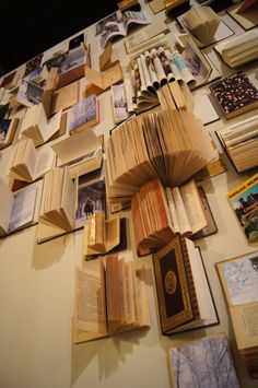 many books are spread out on the table with pictures and photos all over them, including an open book