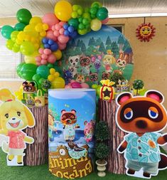 an assortment of animal crossing themed party decorations and balloons in a room with green grass