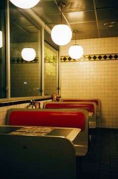 the interior of a diner with red booths