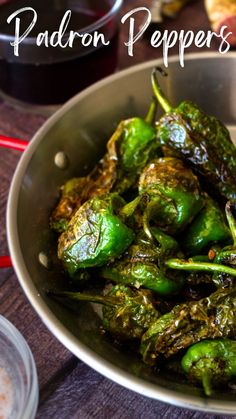 a pan filled with green peppers on top of a table