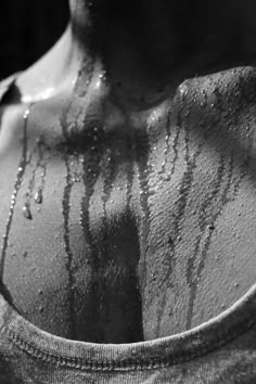 black and white photograph of a man's back covered in water