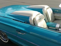 the interior of an old blue convertible car