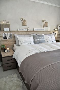 a bedroom with a bed, nightstands and pictures on the wall above it that says good morning