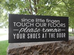 a sign that says, since little fingers touch our floors please remove your shoes at the door