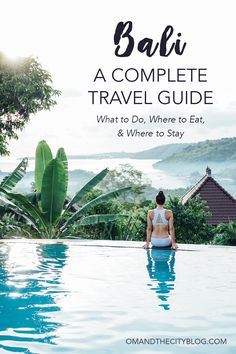 a woman sitting on the edge of a swimming pool with text overlay reading bali a complete travel guide what to do, where to eat and where to stay