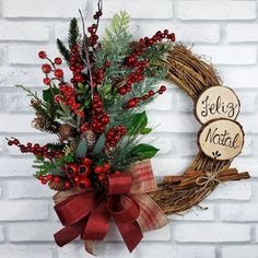 a wreath with red berries and greenery is hung on a brick wall next to a sign that says feli's natt