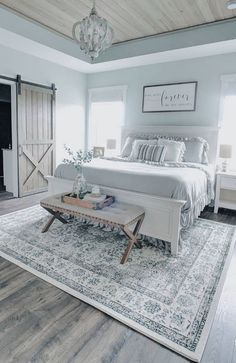 a large bed sitting on top of a wooden floor