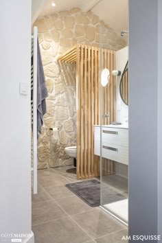 a bathroom with stone walls and flooring