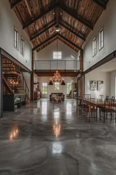 a large open room with high ceilings and wooden beams on the ceiling is lit by candles