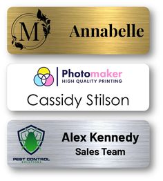 three metal name tags with the names of different companies and their respective company logos on them