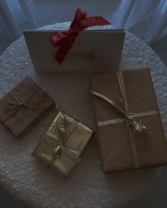 three wrapped presents sitting on top of a table