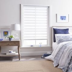 a bedroom with a bed, nightstand and window covered in white blinds on the windowsill