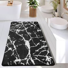 a black and white bathroom rug on the floor