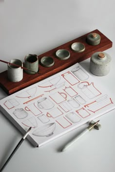 a table topped with lots of crafting supplies on top of a white tablecloth