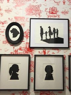 silhouettes of people and children are on the wall next to framed pictures in black frames