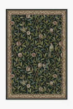 an intricately designed rug with birds and flowers on black ground, surrounded by green leaves