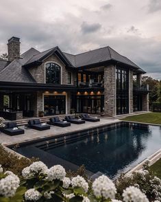 a large house with a pool in front of it