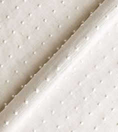 an upholstered fabric with white dots on it