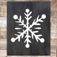 a black and white snowflake on a wooden background