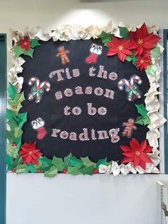 a christmas bulletin board with poinsettis and the words tis the season to be reading