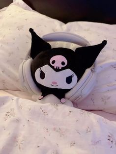 a black and white cat headphone laying on top of a bed