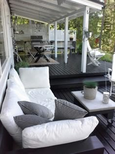 a white couch sitting on top of a wooden deck