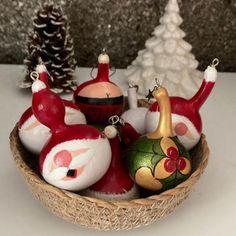 a basket filled with christmas ornaments on top of a table