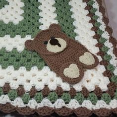 a crocheted blanket with a teddy bear on it