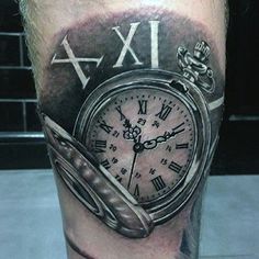 a man's leg with a clock and roman numerals tattoo on it