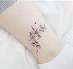 a small flower tattoo on the ankle