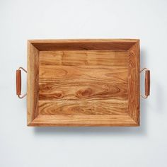 a wooden tray with two handles on the wall