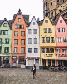 people are standing in front of colorful buildings