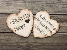 two wooden hearts with names on them