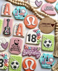 decorated cookies are arranged in the shape of letters, numbers, and other things on display