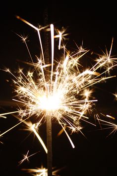 a close up of a sparkler on a black background