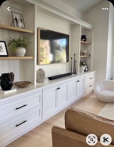 a living room filled with furniture and a flat screen tv on top of a wall