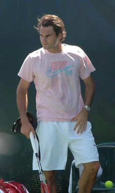 a man holding a tennis racquet on top of a tennis court