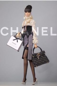 a mannequin holding two purses in front of a grey background with the words chanel on it