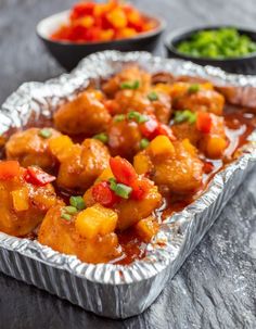 a pan filled with chicken and vegetables on top of a table