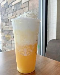 a drink sitting on top of a wooden table